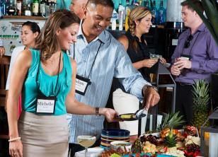 People stand near the table with food